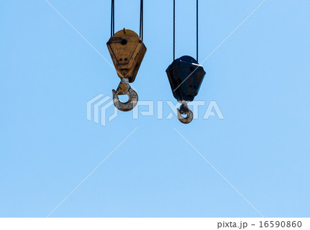 Pair of hanging industrial crane hoists on sky. 16590860