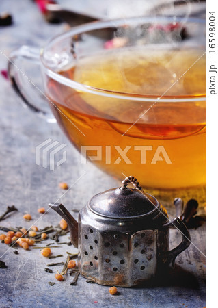 Cup of hot tea with tea strainer 16598004