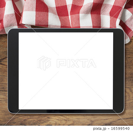 black tablet pc on wooden table and picnic tablecloth 16599540