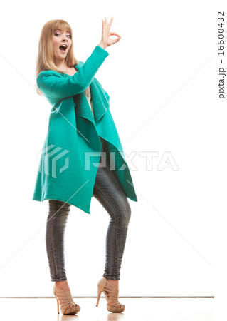 woman green coat making ok sign 16600432