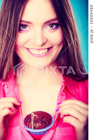 Funny woman holds chocolate cake on chest Funny woman holds chocolate cake on chest 16600489