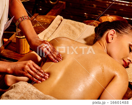 Woman having Ayurvedic spa treatment. Woman having Ayurvedic spa treatment. 16601488