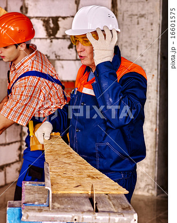 Group people  builder with circular saw . 16601575