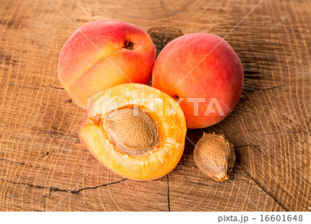 Apricots on the wooden background Apricots on the wooden background 16601648