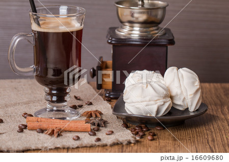 Coffee in glass cup and cinnamon with zephyr 16609680