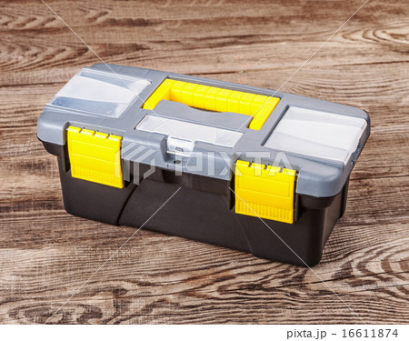 Plastic box of tools on the old board 16611874