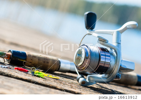 fishing rod on jetty close to lake fishing rod on jetty close to lake 16613912