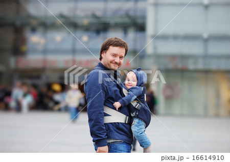 Father and his baby boy in a baby carrier Father and his baby boy in a baby carrier 16614910