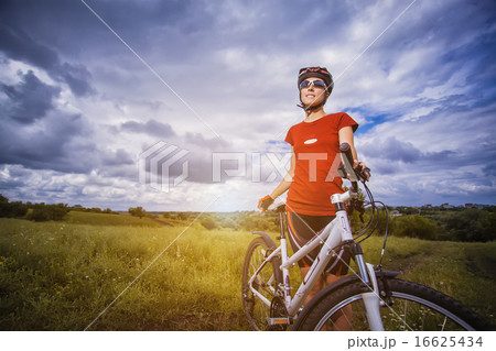 Woman is riding bicycle outside Woman is riding bicycle outside 16625434