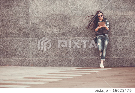 girl with tablet is walking in the downtown girl with tablet is walking in the downtown 16625479