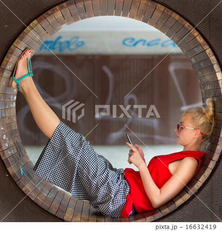 Young cheerful woman using smarthphone. Young cheerful woman using smarthphone. 16632419