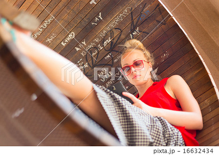 Young cheerful woman using smarthphone. 16632434