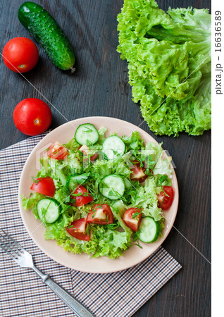 Tomato and cucumber salad with lettuce leafes Tomato and cucumber salad with lettuce leafes 16636589