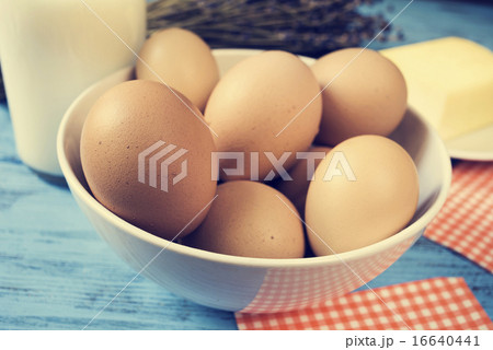 milk, eggs and butter on a blue rustic surface 16640441