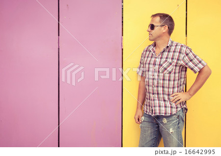 man looking away standing near the wall. man looking away standing near the wall. 16642995
