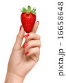 Red Manicured Nails Holding a Strawberry 16658648