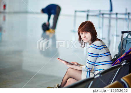 Beautiful young female passenger at the airport 16658662