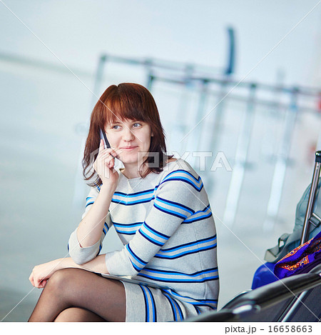 Beautiful young female passenger at the airport 16658663