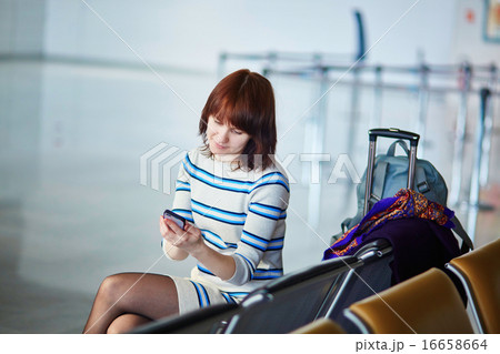 Beautiful young female passenger at the airport 16658664