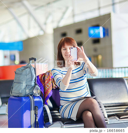 Beautiful young female passenger at the airport 16658665