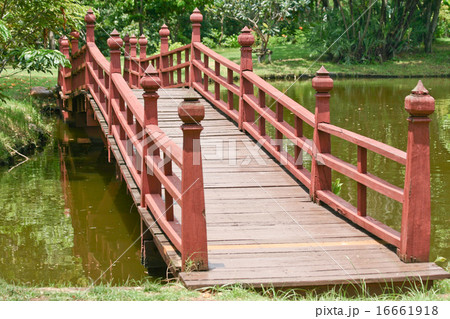 Wooden bridge over a lake Wooden bridge over a lake 16661918