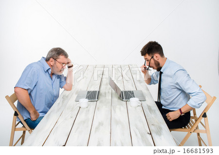 The two colleagues working together  at office on gray background 16681593