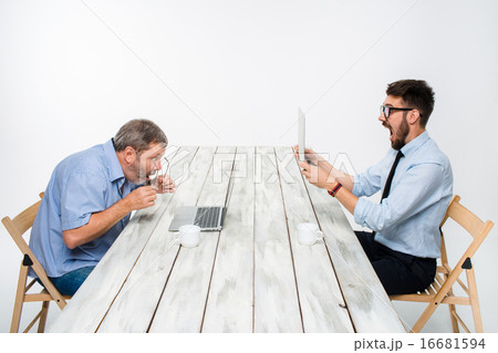 The two colleagues working together at office on gray background The two colleagues working together at office on gray background 16681594