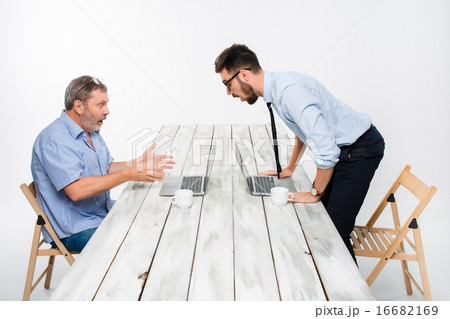 The two colleagues working together  at office on gray background 16682169