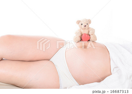pregnant woman with hands and have bear doll 16687313