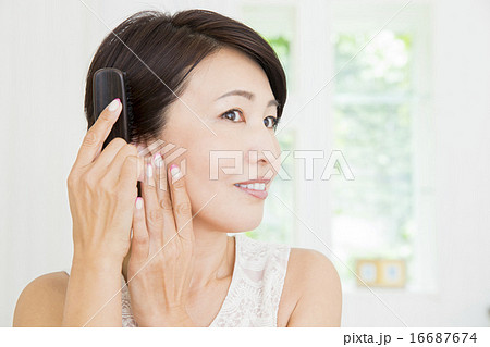 ビューティーイメージ　髪をとかすミドル女性 16687674