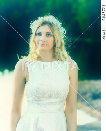 Portrait, attractive blond woman wearing a flower head wreath 16688721