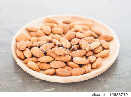 Almond nuts on wooden plate Almond nuts on wooden plate 16688750