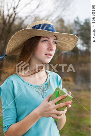Freckled girl in hat standing with note and looking away Freckled girl in hat standing with note and looking away 16690199