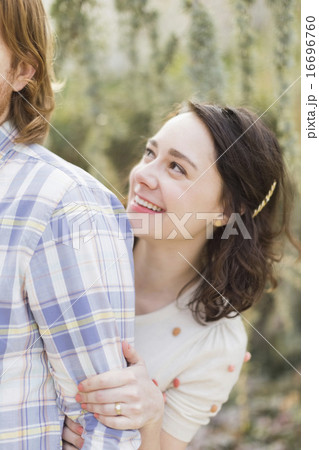 Young woman hiding behind boyfriend 16696760