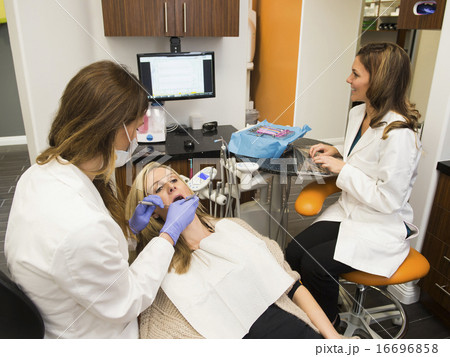 Dentists and patient in dentist's office Dentists and patient in dentist's office 16696858