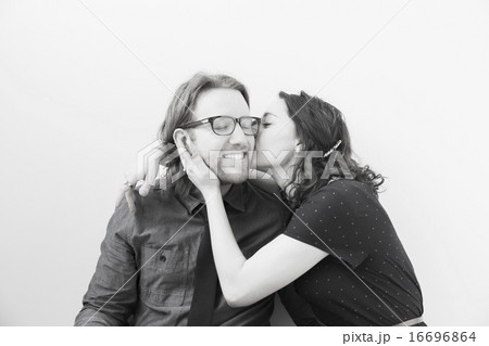 Woman kissing smiling man 16696864