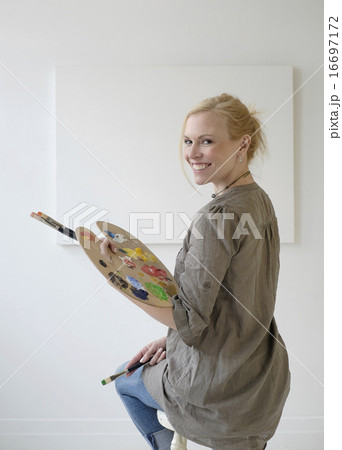 Female artist painting in studio 16697172