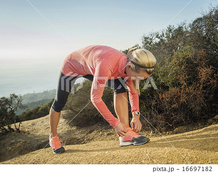 Woman tying shoe Woman tying shoe 16697182