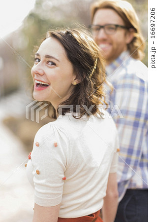 Young smiling woman next to boyfriend Young smiling woman next to boyfriend 16697206
