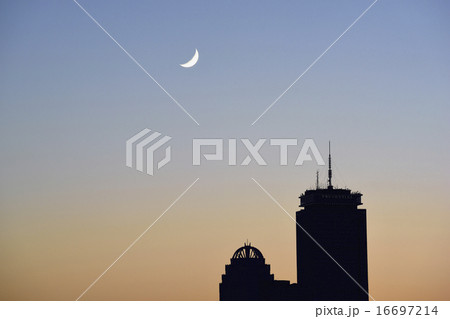 Crescent moon above office buildings 16697214