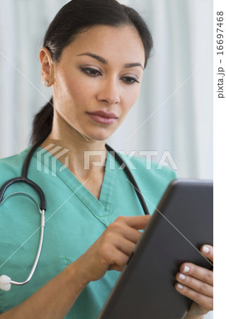 Female doctor using digital tablet Female doctor using digital tablet 16697468