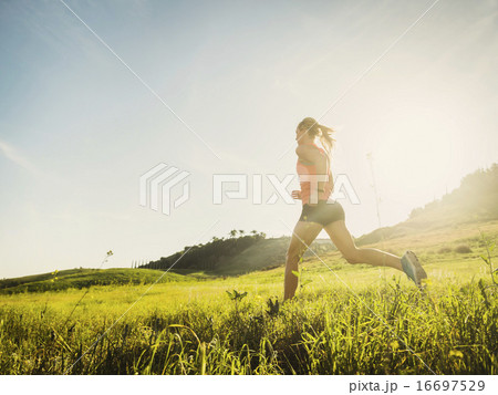 Woman running in field Woman running in field 16697529