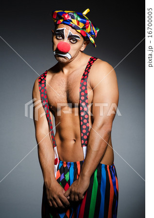 Sad clown against dark background Sad clown against dark background 16700005