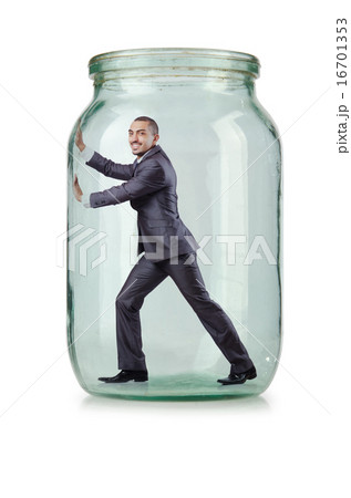 Young businessman in glass jar Young businessman in glass jar 16701353