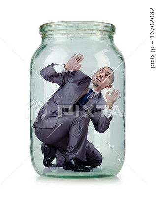 Young businessman in glass jar Young businessman in glass jar 16702082