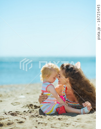 Mother and baby girl playing on beach Mother and baby girl playing on beach 16725445