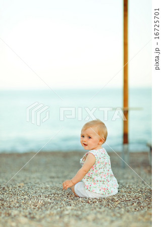 Baby sitting on beach and looking back Baby sitting on beach and looking back 16725701