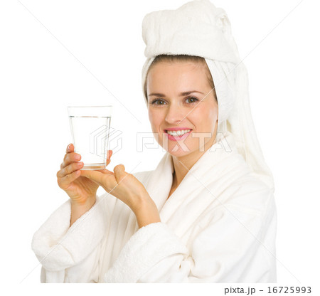 Happy young woman in bathrobe holding glass of water 16725993
