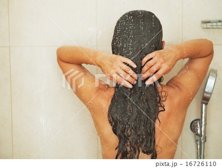 Woman washing hair in shower . rear view 16726110