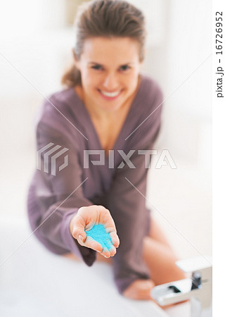 Closeup on young woman showing bath salt Closeup on young woman showing bath salt 16726952